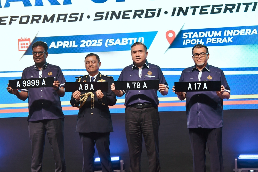 Transport Minister Anthony Loke (2nd right) holds examples of the Perak state registration A_A plate during the JPJ’s 79th Anniversary Celebration at Stadium Indera Mulia in Ipoh April 19, 2025. — Bernama pic