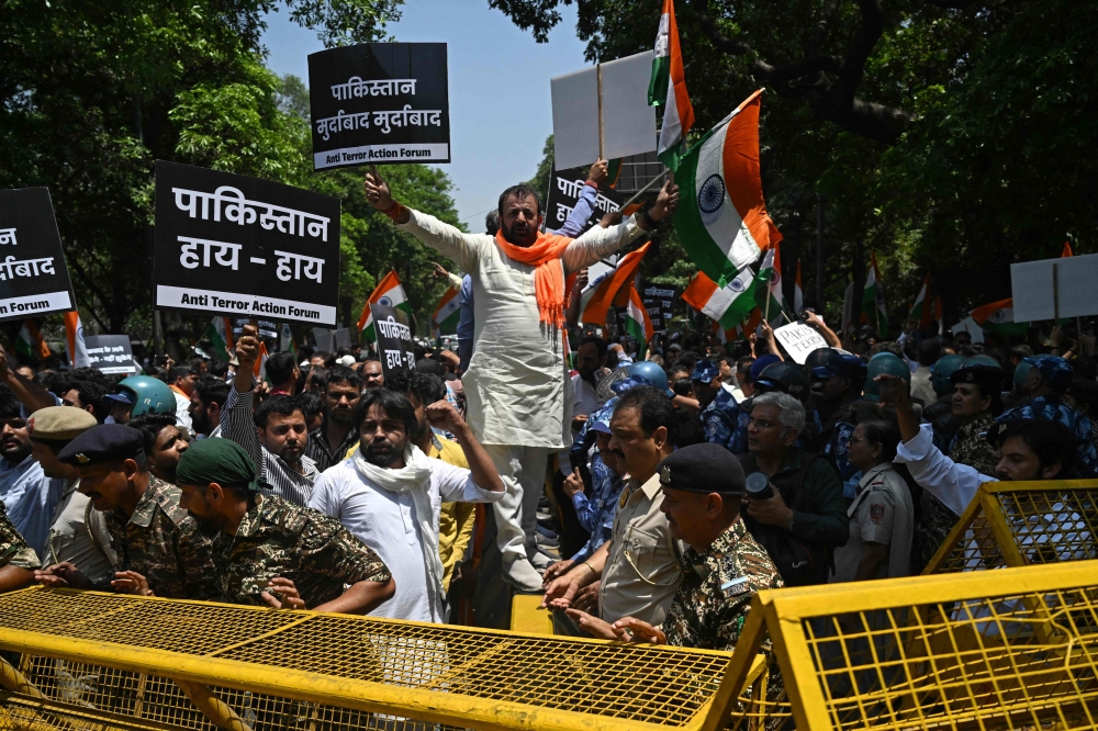 Protesters hold placards during a protest march towards the Pakistan High Commission condemning the Pahalgam tourist attack, in New Delhi today. — AFP pic