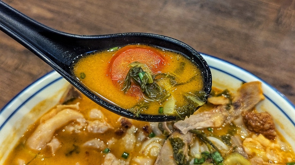 The soup gets its trademark tang from lots and lots of pickled mustard greens and tomatoes. — Picture by Ethan Lau