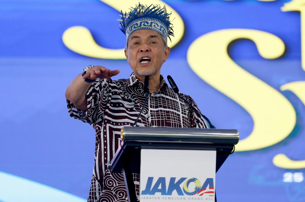 Deputy Prime Minister Datuk Seri Dr Ahmad Zahid Hamidi, speaks at an event with the Orang Asli community in Kampung Orang Asli Sungai Kroh, Tapah today. — Bernama pic