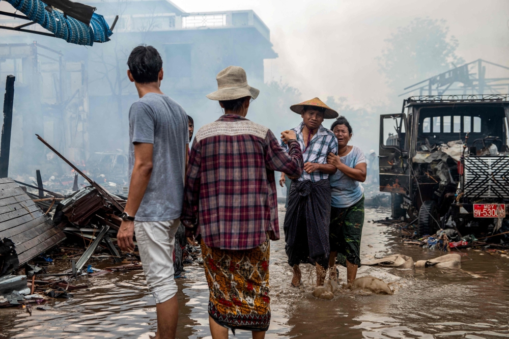 People cry over family members killed in a bombardment carried out by Myanmar's military in Thabeikkyin Township in Mandalay Region of Central Myanmar on April 19, 2025. — AFP pic