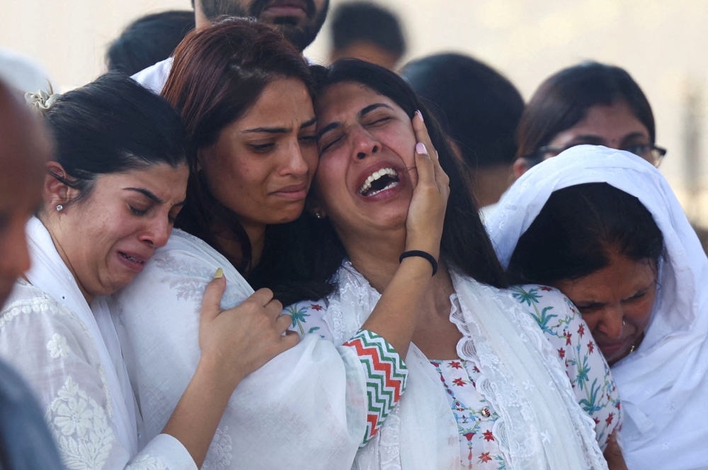 Aayushi Harpalani Udhwani, wife of Niraj Udhwani, who was killed in a suspected militant attack near Pahalgam in south Kashmir, is consoled by relatives during her husband's funeral at a cremation ground in Jaipur, India, April 24, 2025. — Reuters pic