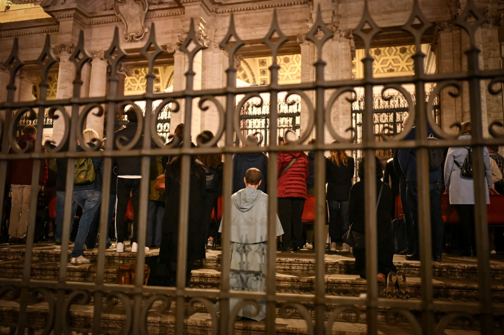 Faithfuls and members of the clergy attend a rosary prayer outside Santa Maria Maggiore Basilica, the late Pope's final resting place, a day prior to the Pope's funeral, in Rome on April 25, 2025.— AFP pic