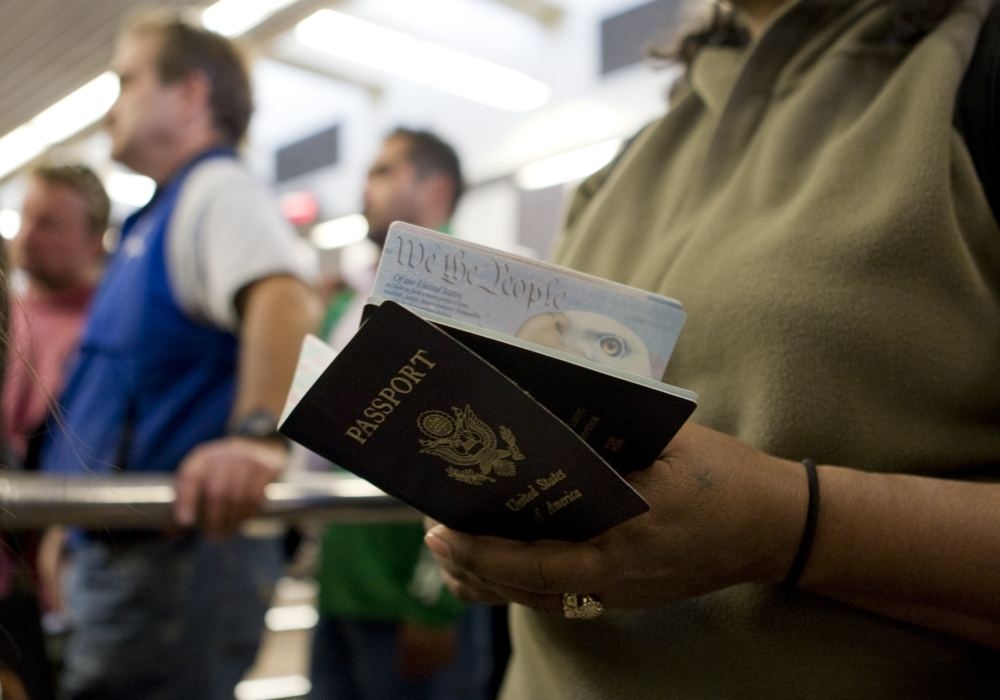 A pedestrian holds her and her child’s passport while waiting to cross into the United States from Mexico at the San Ysidro border crossing in San Ysidro, California in this file photo taken on January 31, 2008. The Trump administration appeared to have deported a 2-year-old US citizen ‘with no meaningful process,’ a federal judge said yesterday, as the child’s father sought to have her returned to the United States. — Reuters pic 