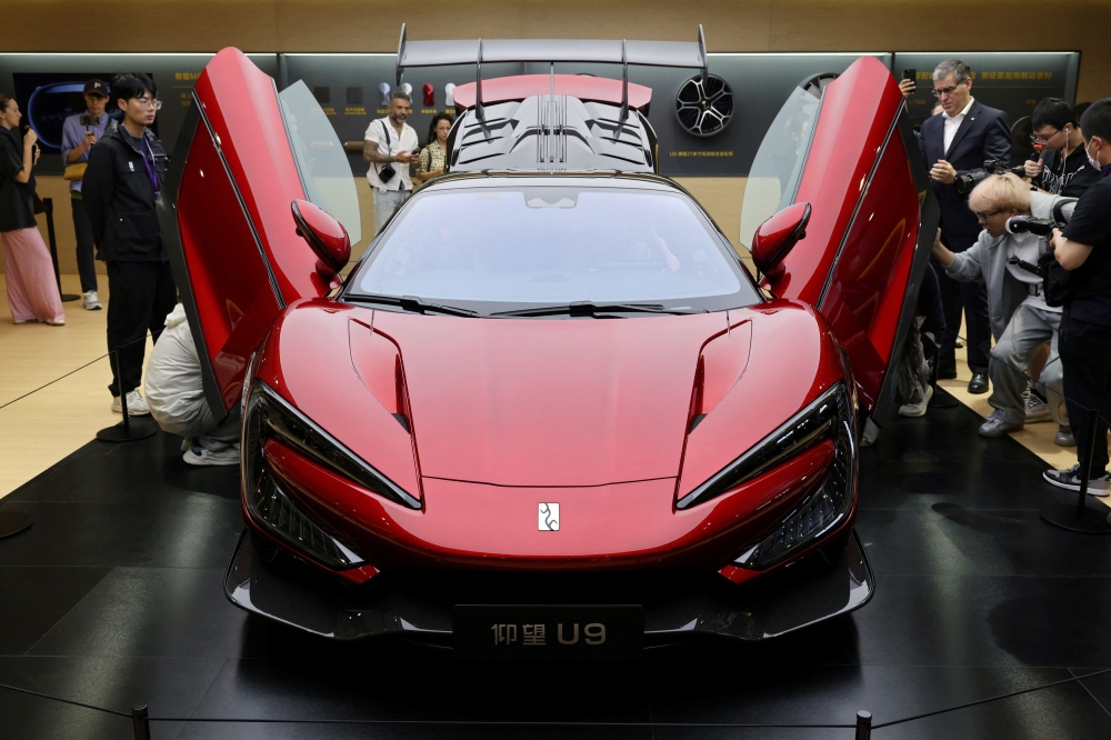 People look at the U9 sports car by Yangwang, a luxury brand under Chinese electric vehicle (EV) giant BYD, during a media day for the Auto Shanghai show in Shanghai April 23, 2025. — Reuters pic  
