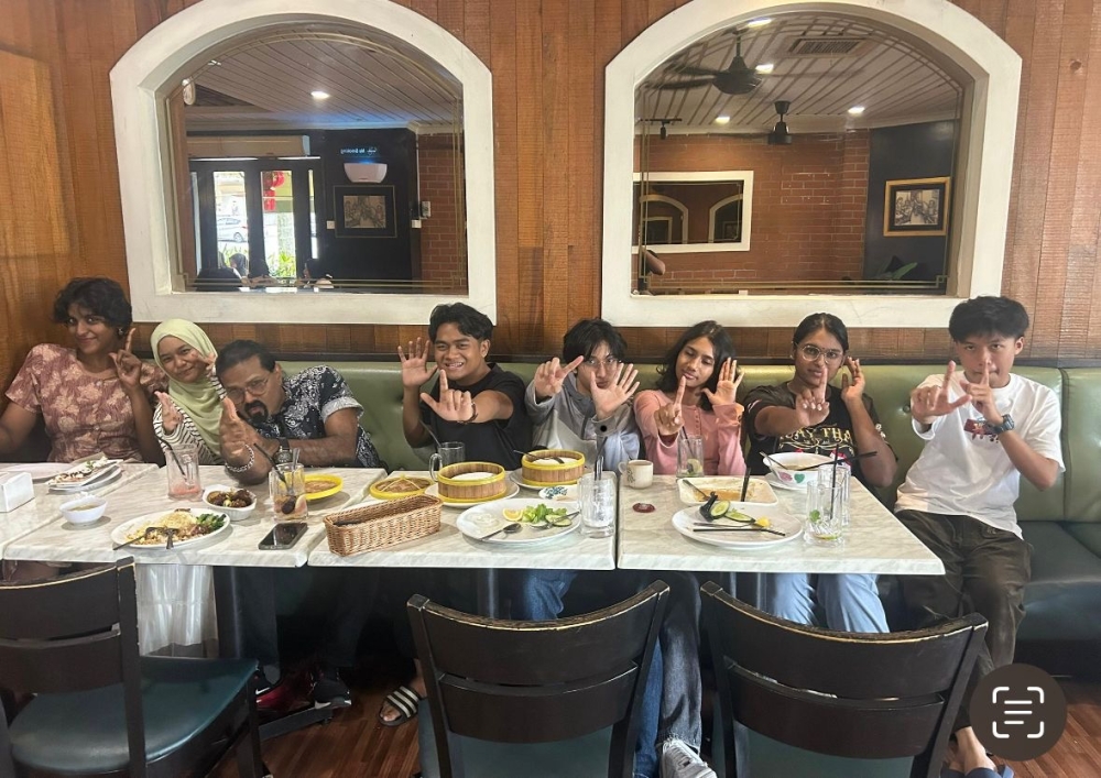Subash (3rd left), 55, celebrate with his students after receiving their 2024 SPM results. — Picture courtesy of Subash Abdullah