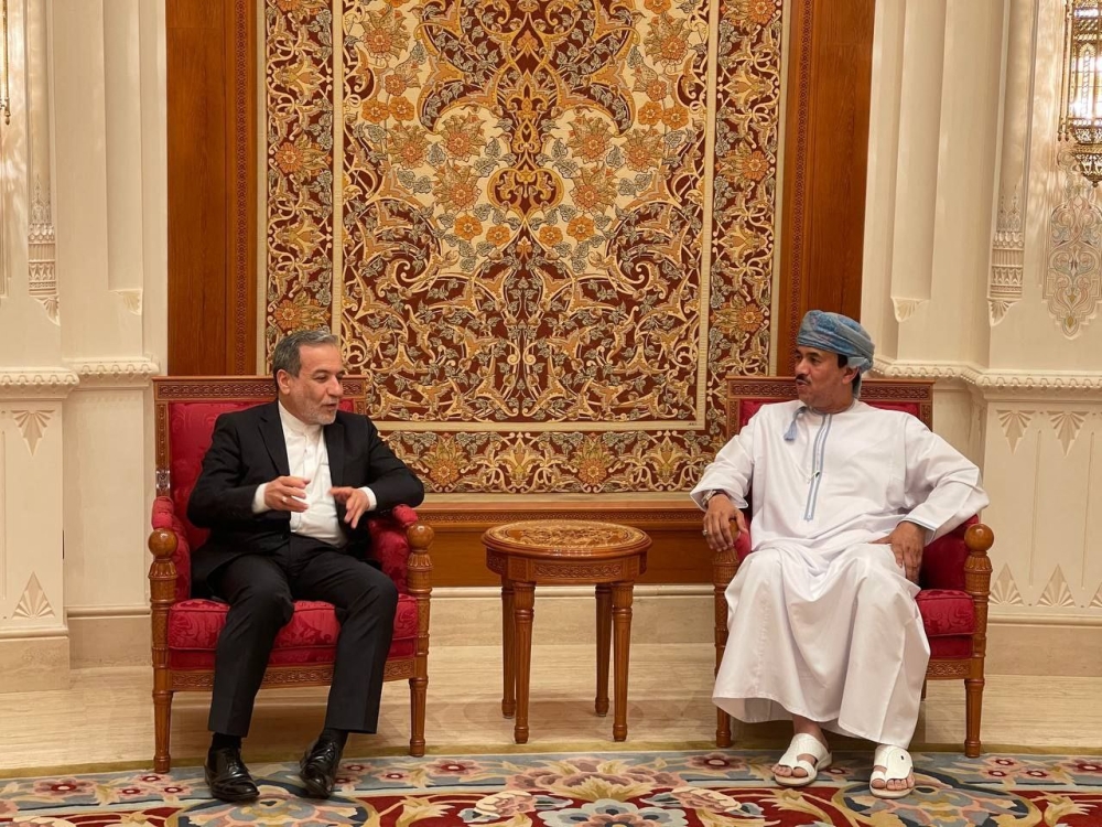 This handout picture provided by the Iranian Foreign Ministry shows Iran's Foreign Minister Abbas Araghchi (left) meeting with an Omani official upon his arrival in Muscat April 25, 2025. — Iranian Foreign Ministry handout/AFP pic 