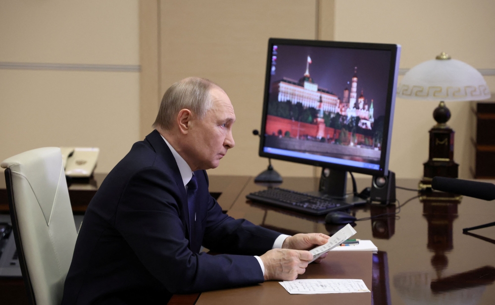 Russian President Vladimir Putin listens to a report of Chief of the General Staff of Russian Armed Forces Valery Gerasimov via video link at the Novo-Ogaryovo state residence outside Moscow April 26, 2025. — Sputnik/Alexander Kazakov/Pool/Reuters pic 