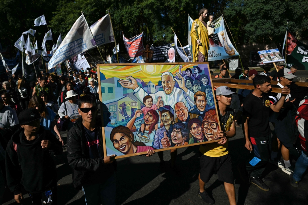 People participate in a pilgrimage to landmarks for Pope Francis in Buenos Aires, Argentina on April 26, 2025, after a mass to bid him farewell. — AFP pic