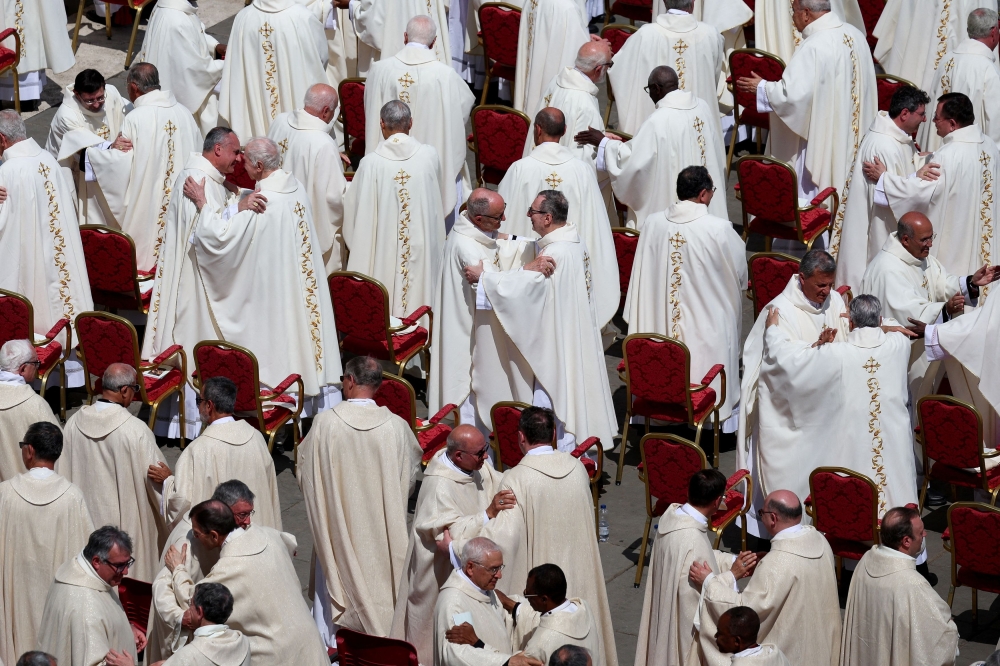 Cardinals hug during Mass for the Vatican workers, following the funeral for Pope Francis, in St. Peter's Square, at the Vatican, April 27, 2025.  — AFP pic