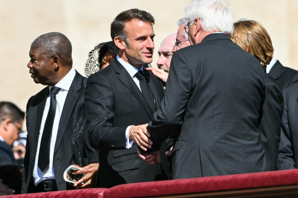 France's President Emmanuel Macron (left) arrives for late Pope Francis' funeral ceremony at St Peter's Square at the Vatican on April 26, 2025. — AFP pic
