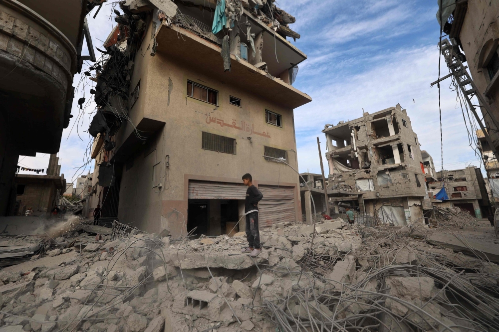 A Palestinian boy stands amid the rubble of a building destroyed in an Israeli strike at the Bureij refugee camp in the central Gaza Strip on April 27, 2025. A Hamas delegation is in Cairo to discuss with Egyptian mediators ways out of the 18-month war while, on the ground, rescuers said Israeli strikes in Gaza killed at least 35 people. — AFP pic