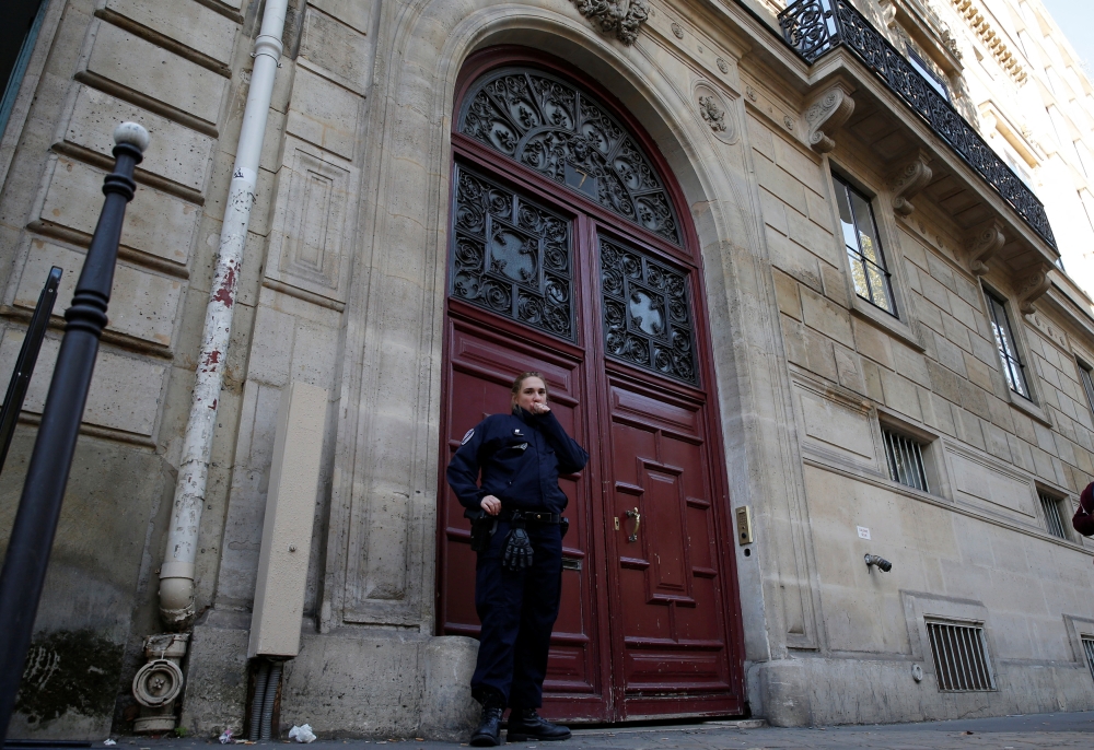 A police officer stands guard at the entrance of a luxury residence on the Rue Tronchet in central Paris, France, October 3, 2016 where Kim Kardashian was held at gunpoint and robbed. — Reuters pic
