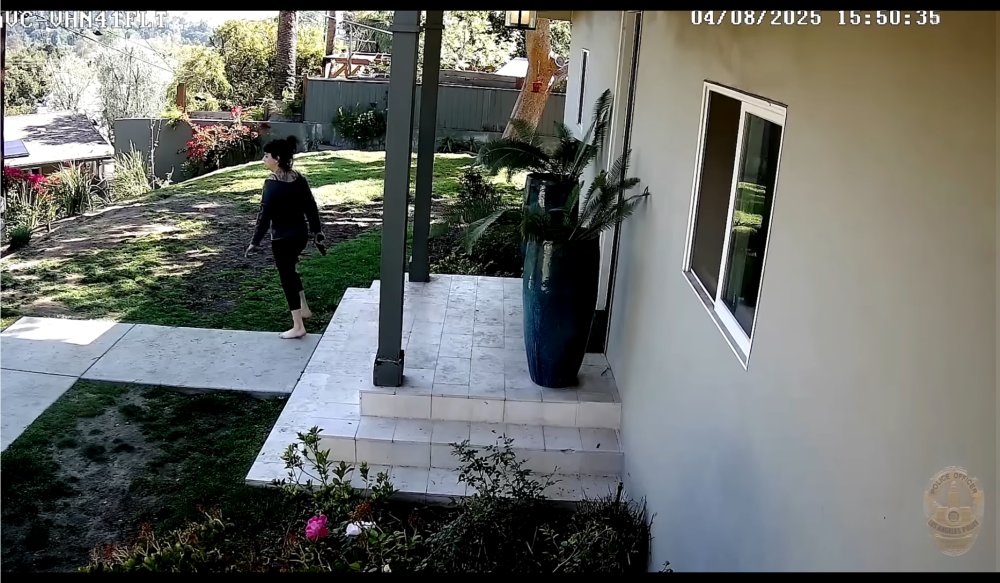 A still image from surveillance footage shows Jillian Shriner holding a gun outside her home.