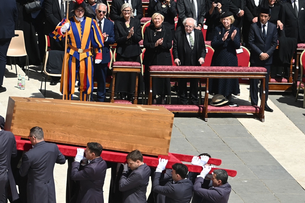 Former Indonesian president Joko Widodo (right) stand with other world leaders as pallbearers carry Pope Francis’ casket during the latter’s funeral ceremony at St Peter's Square, Vatican City on April 26, 2025. — AFP pic