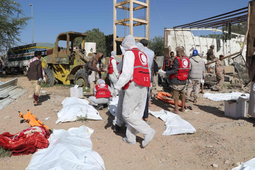 Yemeni rescuers transport the bodies of victims pulled from the rubble of a building hit in US strikes in the northern province of Saada on April 28, 2025. — AFP pic 