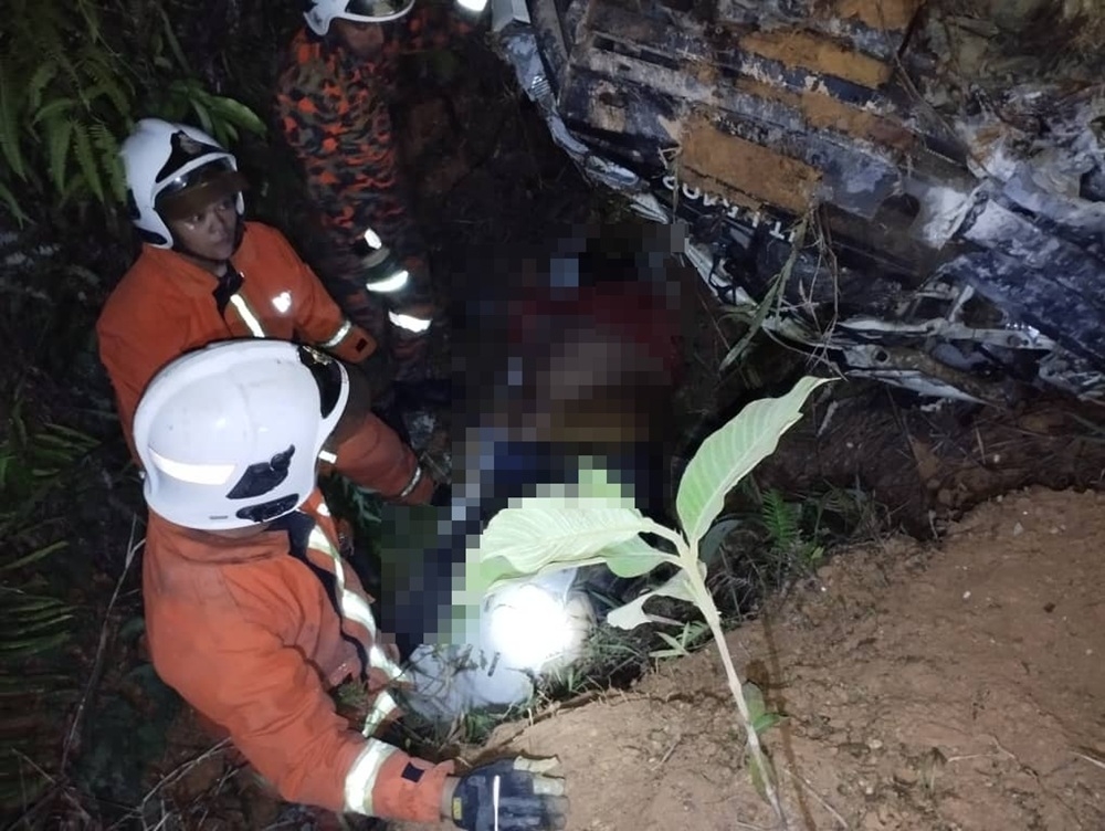 Firefighters extricate one of the victims from the vehicle. — Picture courtesy of the Fire and Rescue Department 