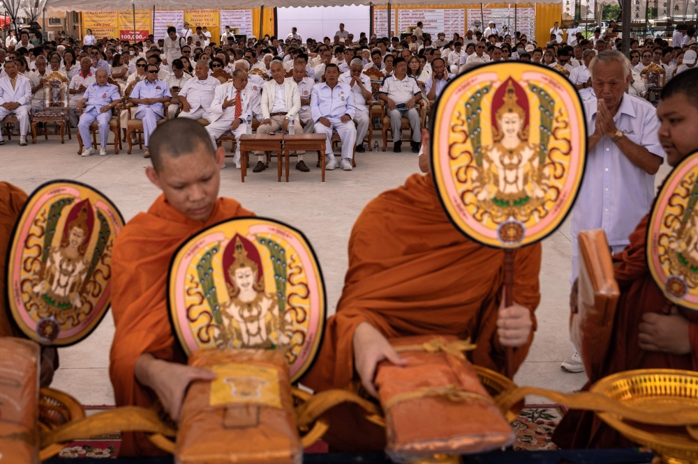 This photo taken on April 23, 2025 shows Buddhist monks praying for unclaimed bodies on the cremation day during the Lang Pacha ceremony at the Dhamma of Buddha Nakhon Ratchasima Foundation complex in Thailand's Nakhon Ratchasima province. — AFP pic
