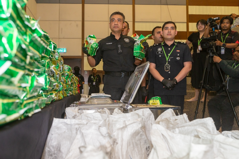 Acting Director DCP Mat Zani @ Mohd Salahuddin Che Ali shows drug packages disguised as tea packets during the Narcotics Criminal Investigation Department press conference at Bukit Aman April 29, 2025. — Picture by Raymond Manuel