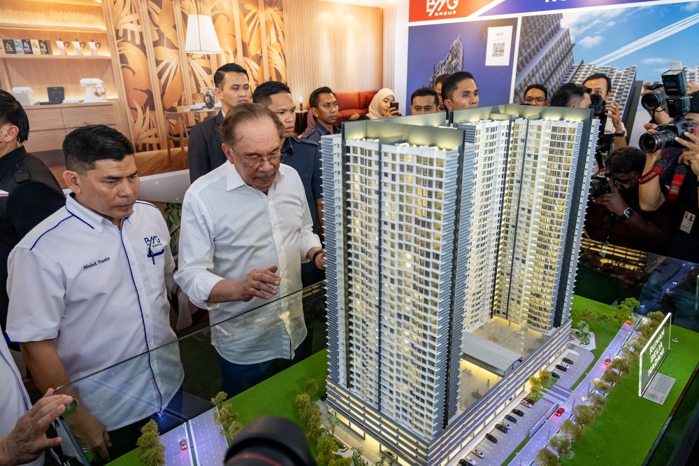 Prime Minister Datuk Seri Anwar Ibrahim looks at a scale model during the groundbreaking ceremony for the Rumah Belia Madani and Affordable Housing Development Project in Mukim Batu, Kuala Lumpur, April 29, 2025. — Picture by Firdaus Latif