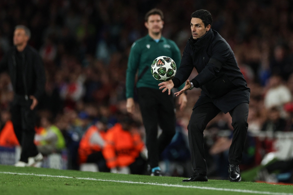 Arsenal's Spanish manager Mikel Arteta catches the ball during the UEFA Champions League Semi-final First Leg football match between Arsenal and Paris Saint-Germain (PSG) at the Emirates Stadium in north London, on April 29, 2025. — AFP pic