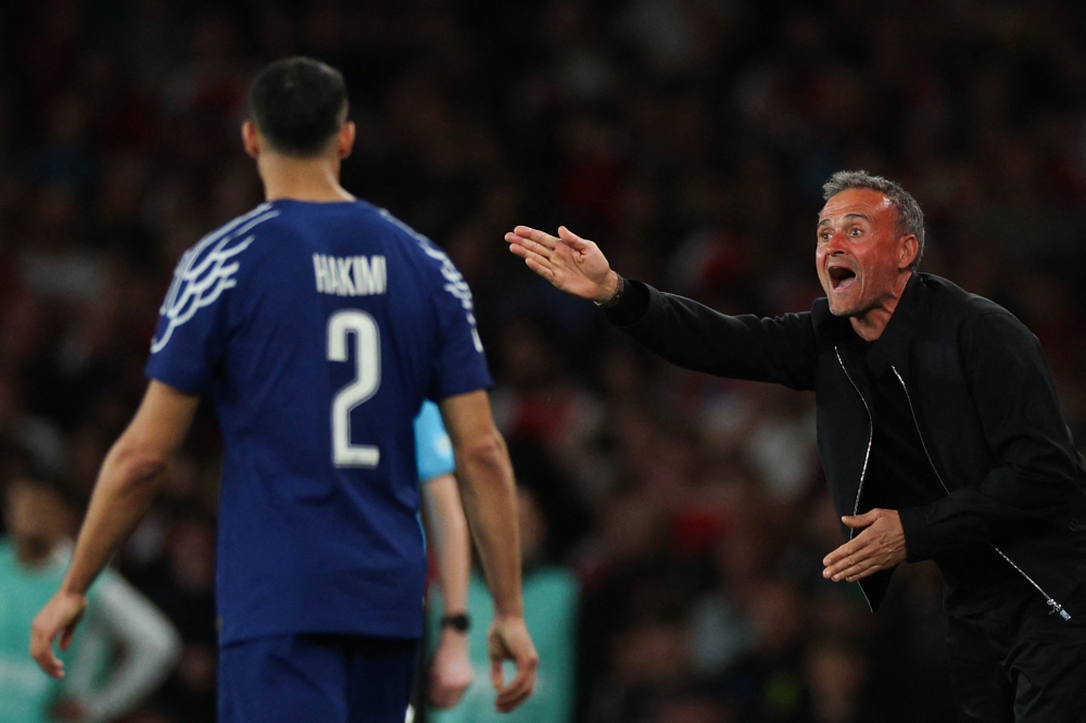 Paris Saint-Germain's Spanish head coach Luis Enrique (right) shouts instructions to Paris Saint-Germain's Moroccan defender #02 Achraf Hakimi (left) during the UEFA Champions League Semi-final First Leg football match between Arsenal and Paris Saint-Germain (PSG) at the Emirates Stadium in north London, on April 29, 2025. — AFP pic
