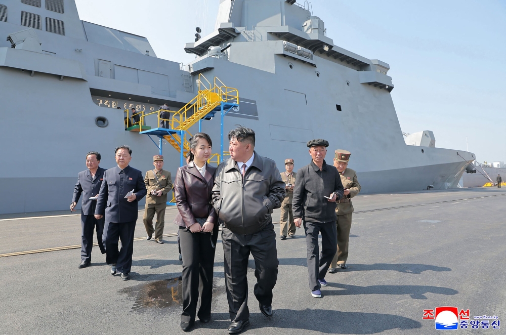 This undated picture released from North Korea's official Korean Central News Agency (KCNA) via KNS on April 30, 2025 shows North Korea's leader Kim Jong Un (centre right) with his daughter Ju Ae (centre left) attending the test-firing of a weapons system from North Korea's latest destroyer, the Choe Hyon (behind), during two days of tests on April 28-29 off the coast of an undisclosed location in North Korea. North Korean leader Kim Jong Un has ordered steps to be taken to accelerate the arming of navy vessels with nuclear weapons, state media reported on April 30. — KCNA via KNS/AFP pic