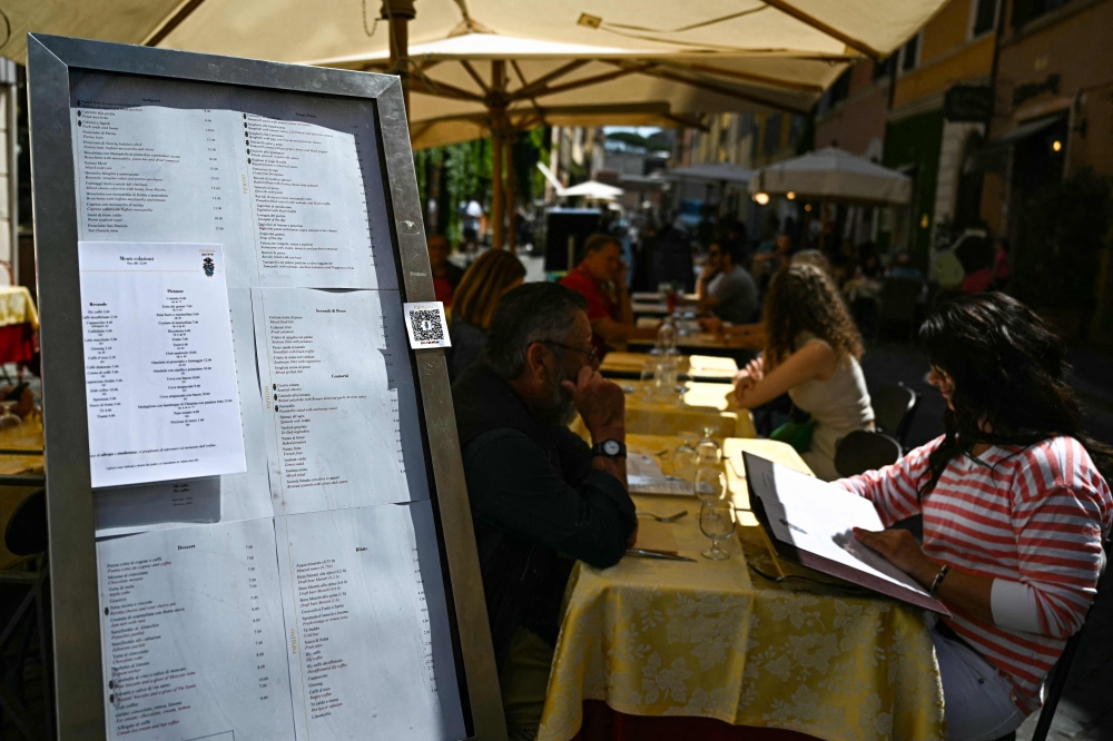 Clients sit at a restaurant terrace on Borgo Pio street in Rome, on April 29, 2025. — AFP pic
