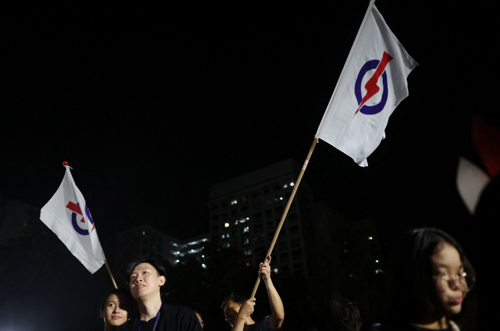 Supporters of the People’s Action Party (PAP) attend rally ahead of the general election in Singapore April 26, 2025. — Reuters pic