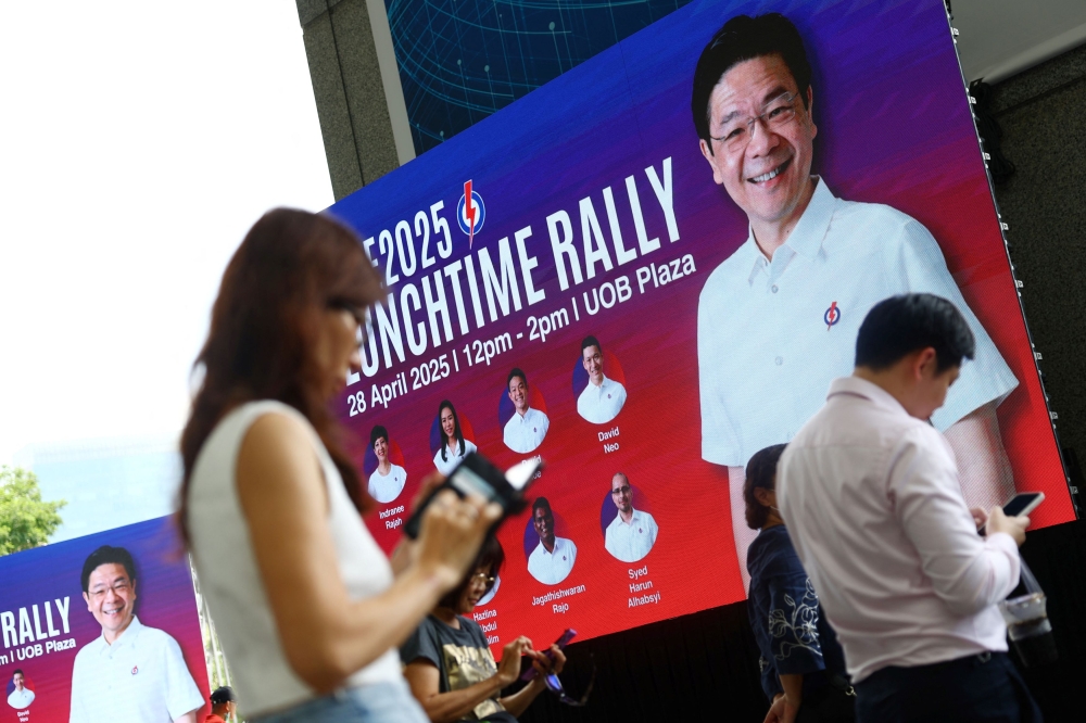 Office workers attend a People’s Action Party (PAP) lunchtime rally ahead of the general election, in Singapore’s central business district, April 28, 2025. — Reuters pic