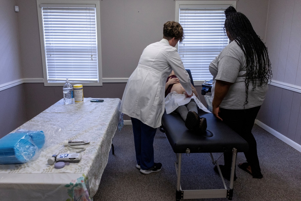 Doctors do an ultrasound on a pregnant woman during a pop-up health clinic sponsored by WAWC Healthcare, formerly West Alabama Women’s Centre, in Reform, Alabama, U.S., June 29, 2024. — Reuters pic
