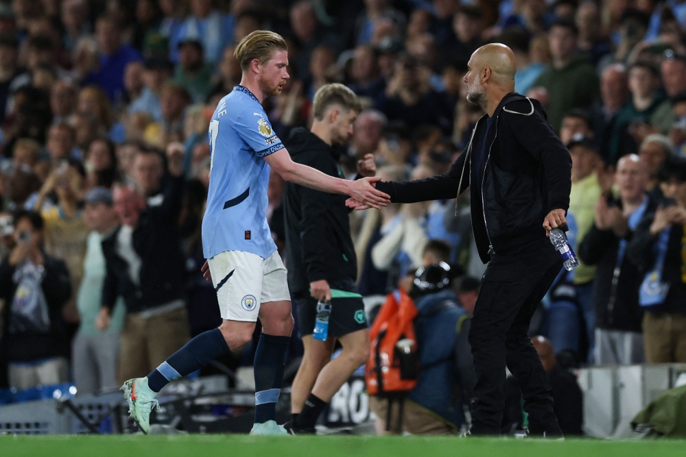 Manchester City's Spanish manager Pep Guardiola (R) congratulates Manchester City's Belgian midfielder #17 Kevin De Bruyne as he leaves the picth during the English Premier League football match between Manchester City and Wolverhampton Wanderers at the Etihad Stadium in Manchester May 2, 2025. — AFP pic