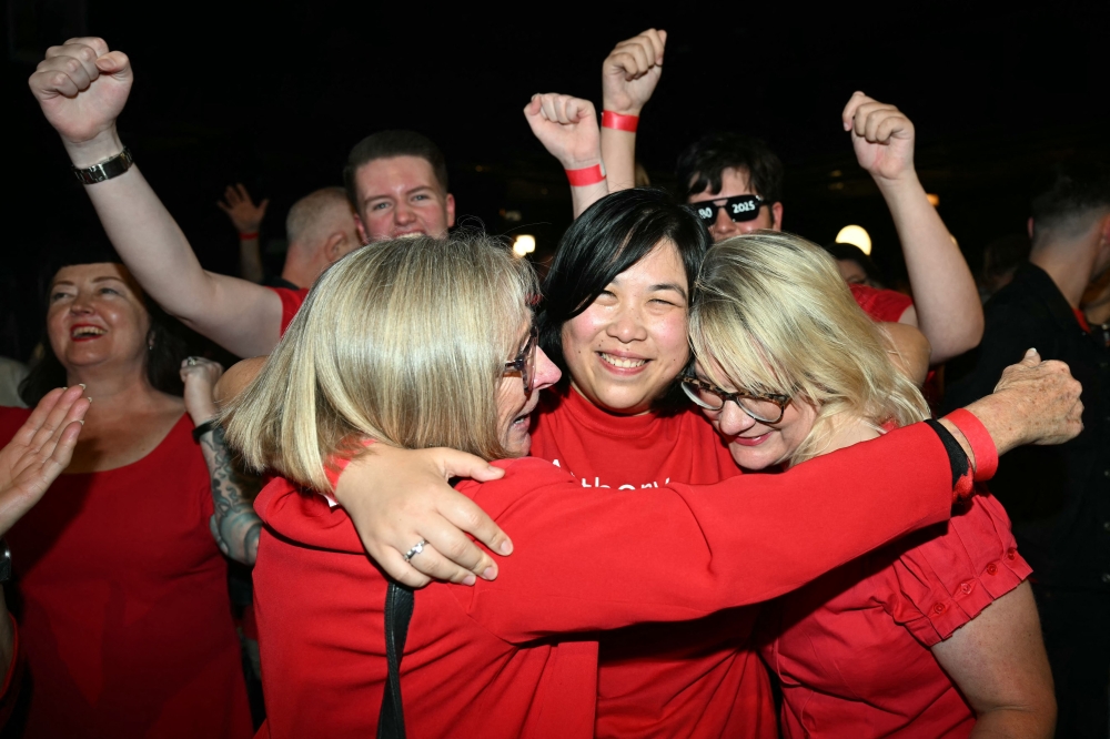 Labor Party supporters react as votes are counted in the general election at the party's election night event in Sydney on May 3, 2025. — AFP pic