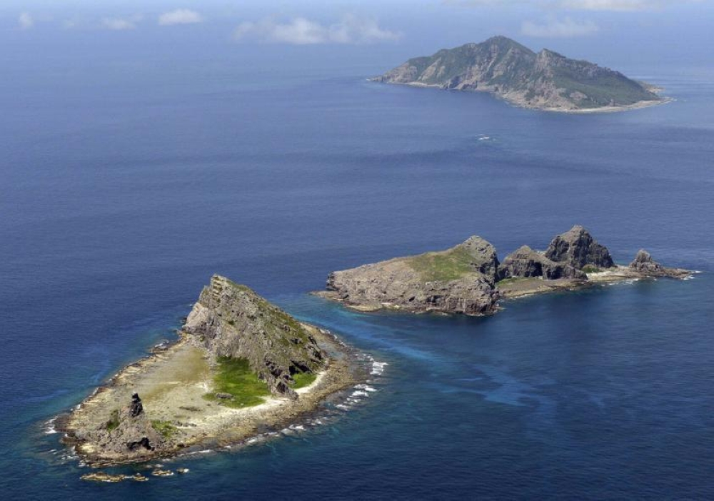 A group of disputed islands, Uotsuri island (top), Minamikojima (bottom) and Kitakojima, known as Senkaku in Japan and Diaoyu in China is seen in the East China Sea, in this photo taken by Kyodo September 2012. — Reuters pic