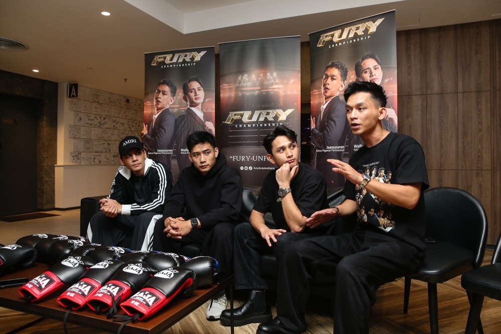 (Left to right) Fury Championship chief marketing officer, Mohd Faizal Ahmad, Fury Championship chief executive officer, Mohd Wafiy Ilhan along with local actors and models Hun Haqeem and Ikmal Amry during the pre-match press conference. — Picture by Yusof Mat Isa