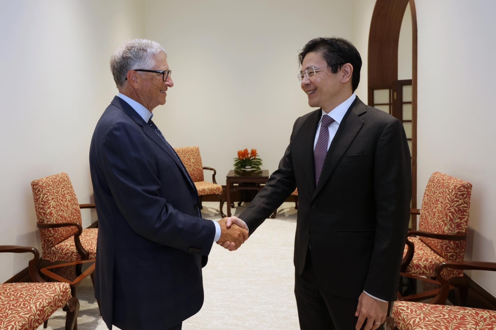 Bill & Melinda Gates Foundation chairman Bill Gates (left) and Singapore Prime Minister Lawrence Wong seen shaking during a meeting in Singapore yesterday. — Picture via Facebook/Lawrence Wong