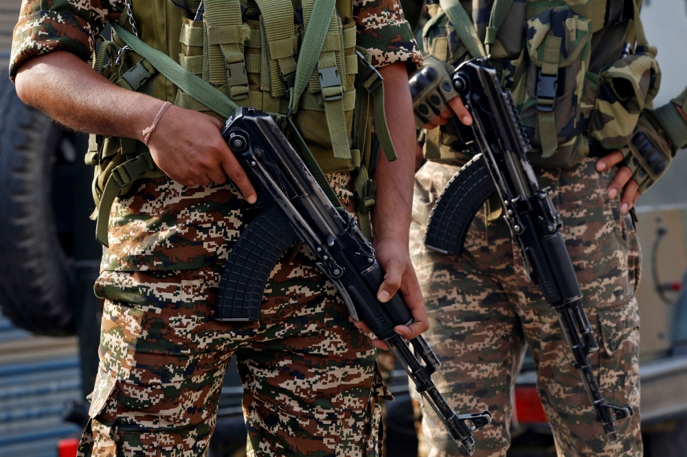 Indian security force personnel stand guard near the site of a fighter jet crash in Wuyan in south Kashmir’s Pulwama district May 7, 2025. — Reuters pic