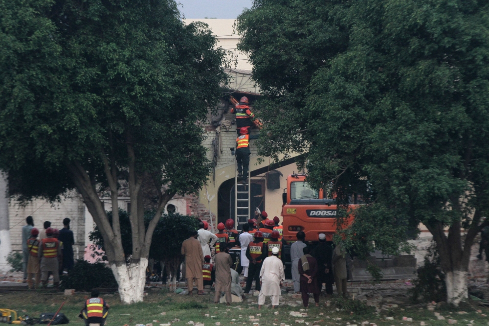 Rescuers search for survivors in a damaged building after it was hit by an Indian strike in Muridke near Lahore, Pakistan today. — Reuters pic