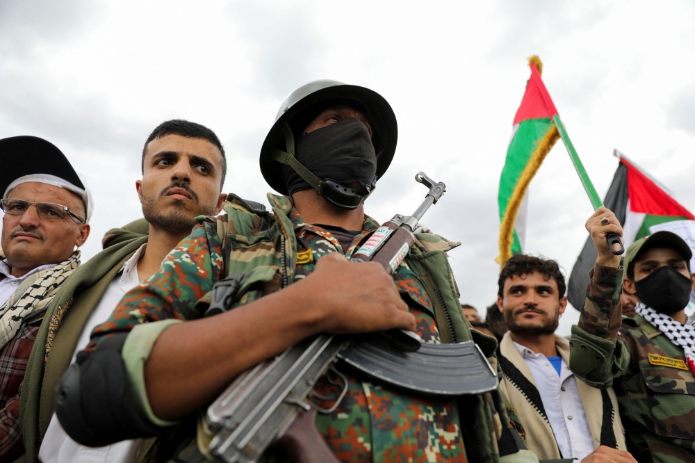 A Houthi fighter stands guard as protesters, mainly Houthi supporters, rally in solidarity with Palestinians, in Sanaa May 2, 2025. — Reuters pic 