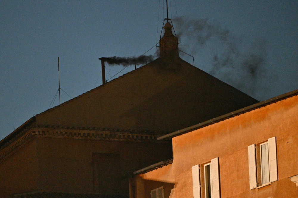 This photograph shows black smoke rising from the chimney of the Sistine Chapel signalling that cardinals failed to elect a new pope in the first ballot of their conclave in the Vatican yesterday. — AFP pic