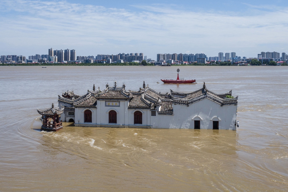 The photo taken on July 6, 2024 shows an aerial view of a partially submerged Guanyin temple in floodwaters in the swollen Yangtze River, in Ezhou, in central China's Hubei province. — AFP pic