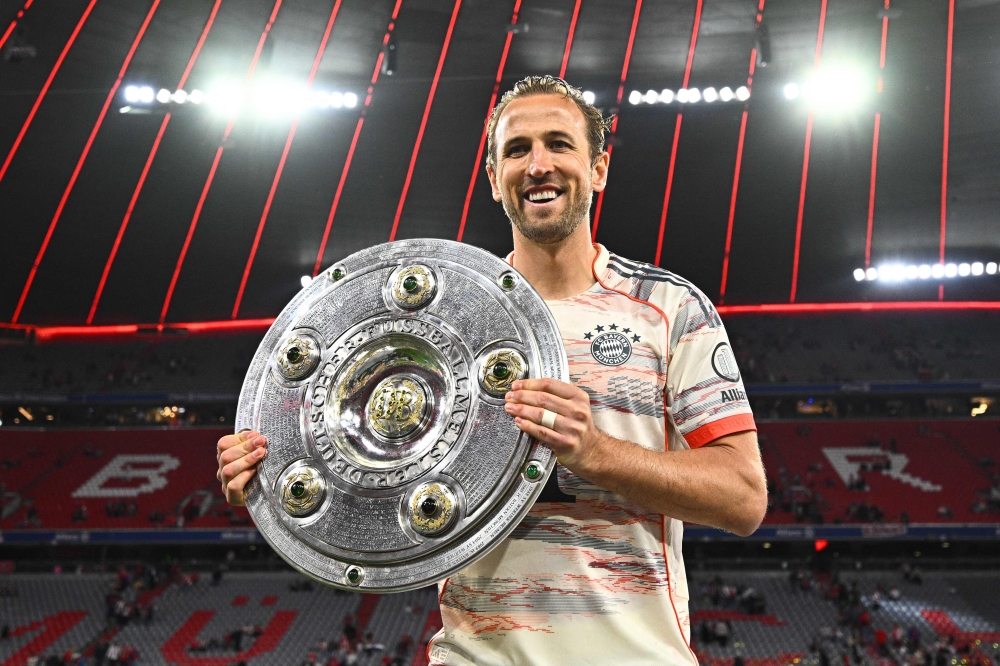 Bayern Munich English forward #09 Harry Kane celebrates with the trophy after the German first division Bundesliga football match between Bayern Munich and Borussia Moenchengladbach in Munich on May 10, 2025. — dpa pic via AFP