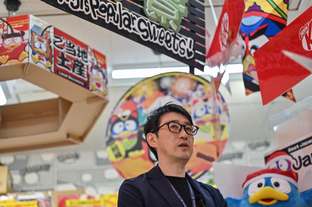 This photo taken on April 21, 2025 shows Motoki Hata, inbound support department manager, speaking during an interview with AFP at a branch of Japanese discount retailer Don Quijote, also known overseas as Don Don Donki, in the Shibuya district of central Tokyo. — AFP pic