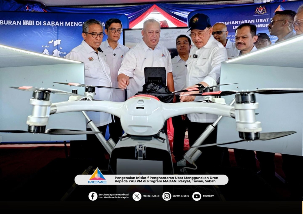 Prime Minister Datuk Seri Anwar Ibrahim (fifth from left) observing a drone that will be used in a pilot project for medicine delivery, during the Sabah Madani Rakyat Programme (PMR) at Tawau Municipal Council Square yesterday. — Bernama pic