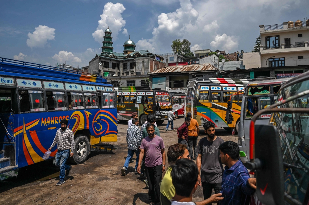 People gather at a bus station in the main town of Poonch district in Jammu region on May 11, 2025. A ceasefire appeared to hold on May 11 between India and Pakistan, hours after the nuclear-armed rivals accused each other of violating a truce that brought them back from the brink of all-out war. — AFP pic 