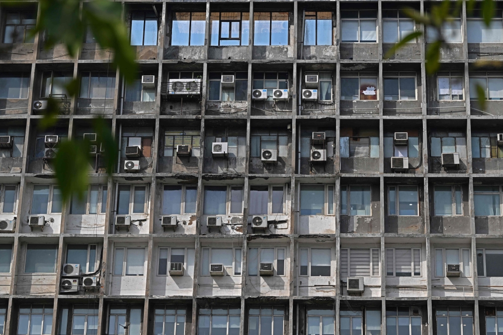 A general view of air-conditioning units installed on the facade of a building in New Delhi. — AFP pic