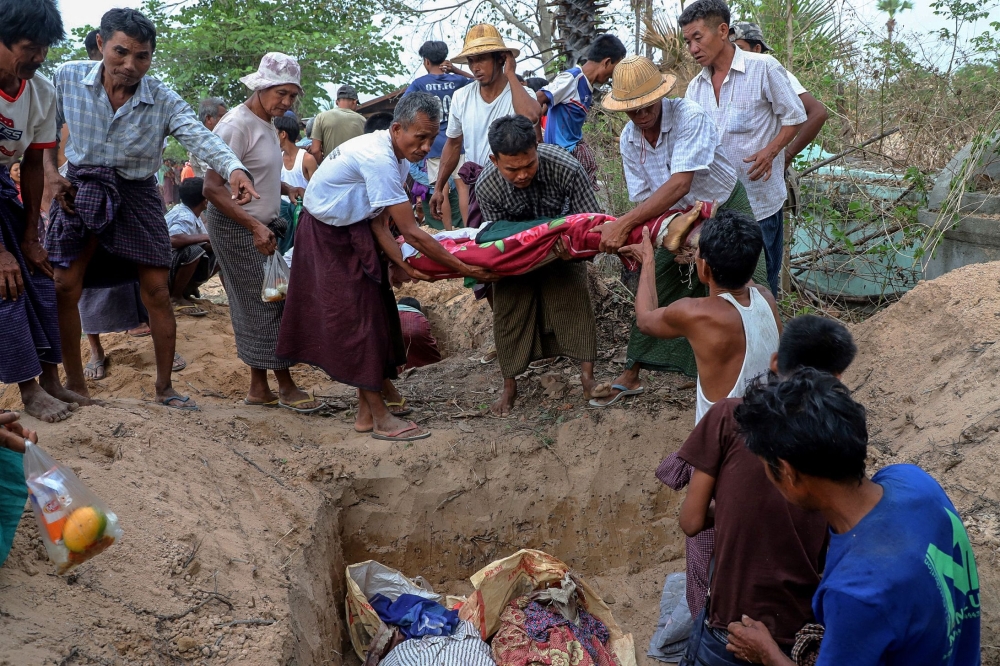 People carry the dead body of a victim, who was killed in a bombardment carried out by Myanmar’s military, during a funeral at the Ohe Htein Twin village in Tabayin township, Sagaing Region, on May 12, 2025. A Myanmar junta airstrike hit a school on May 12 killing 22 people, including 20 children, witnesses said, despite a purported humanitarian ceasefire called to help the nation recover from a devastating earthquake. — AFP pic
