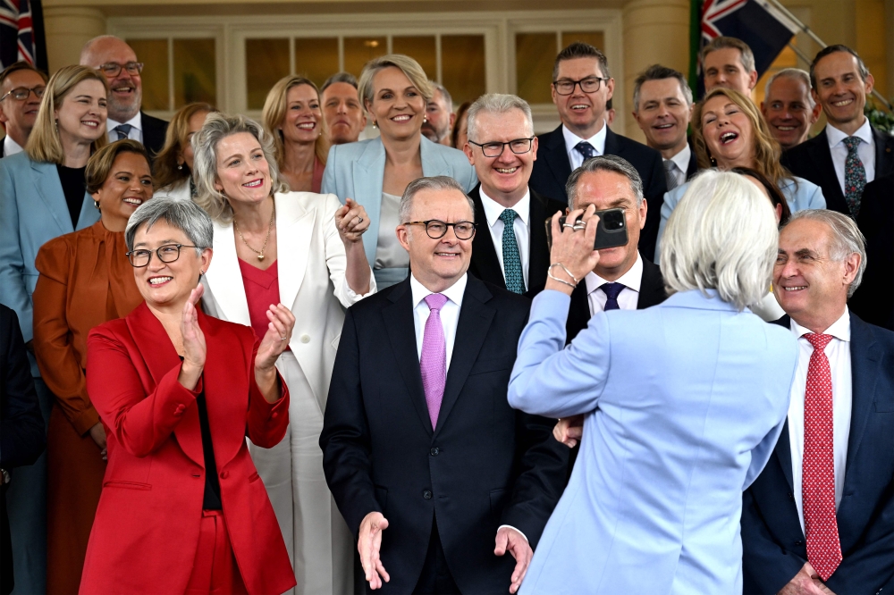 Australia’s Governor General Sam Mostyn shows a selfie to Australia’s re-elected Prime Minister Anthony Albanese (centre) and his cabinet members after a swearing-in ceremony at Government House in Canberra on May 13, 2025. — AFP pic 