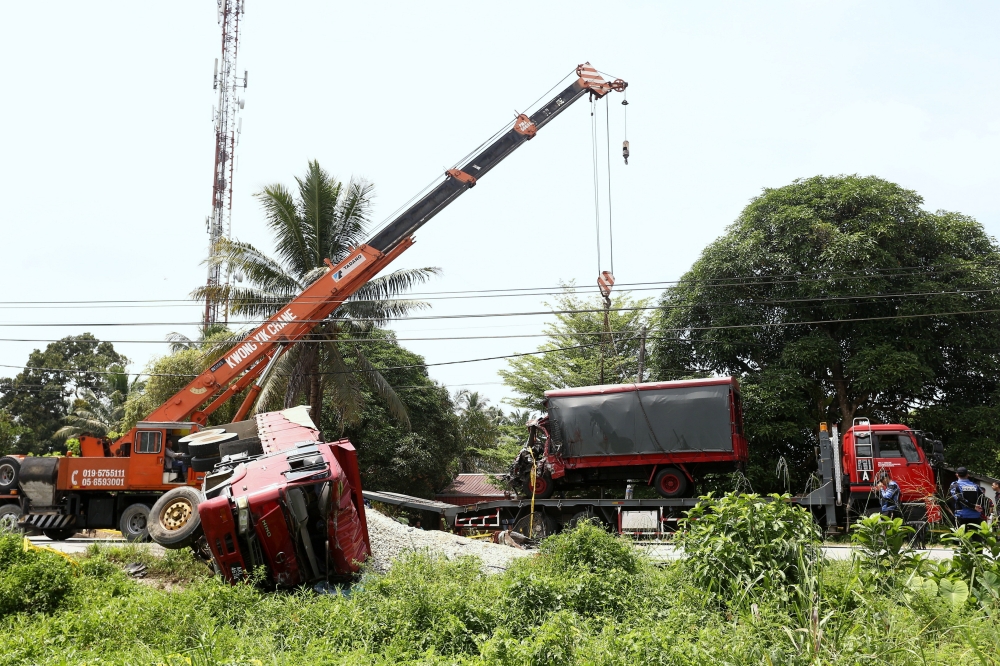 The sand lorry driver escaped unhurt from the collision with the FRU truck and is currently in police custody for investigation under Section 41 of the Road Transport Act 1987. — Bernama pic 