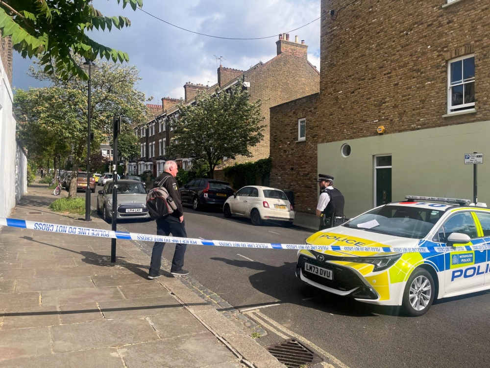 A person walks to a police officer at a cordoned off street, where a fire broke out at Britain’s Prime Minister Keir Starmer’s home in the early hours of Monday, in north London, Britain, May 12, 2025. — Reuters pic 